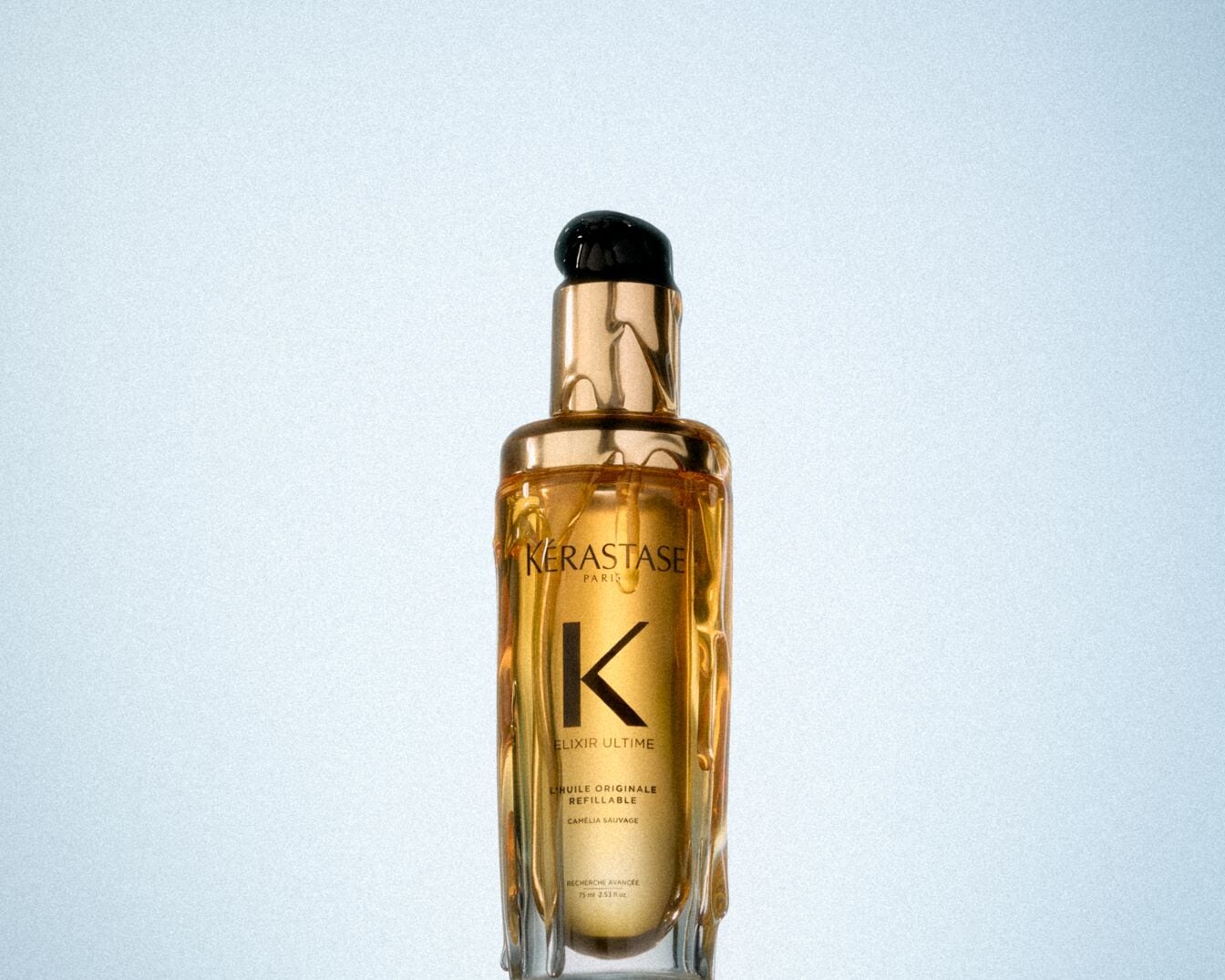 Musta korgi ja kuldse pudeliga K&Eacute;RASTASE Elixir Ultime L'Huile Originale l&auml;hivaade.